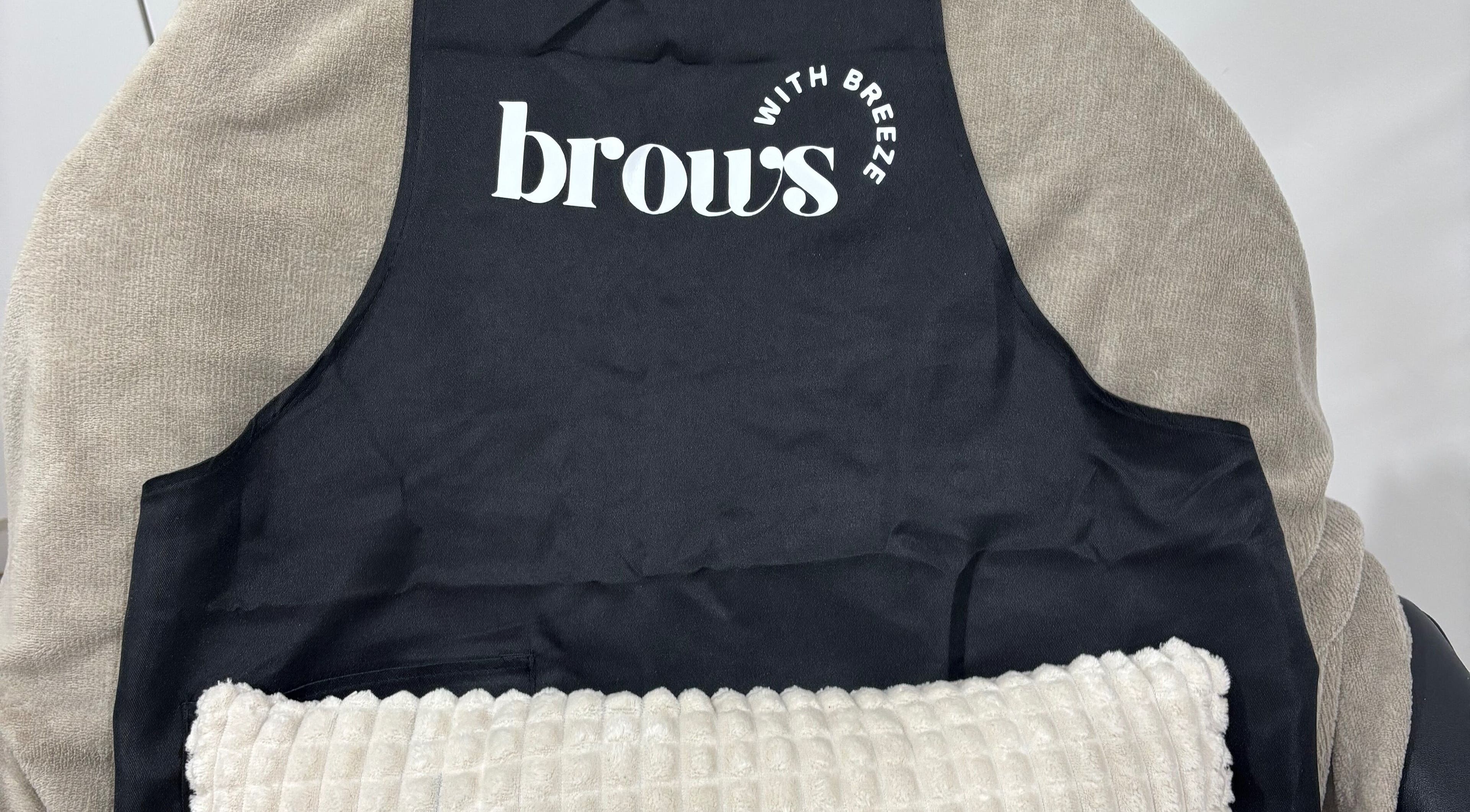 Comfortable treatment chair at Brows With Breeze, Rainworth, England, GB with branded cover.