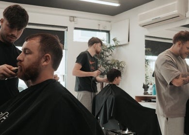 Stylists at Unit 72 Barbershop in Cheltenham, England, GB, are crafting modern haircuts for satisfied clients.