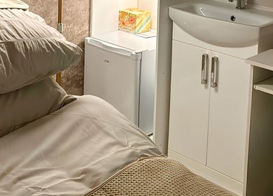 Cozy treatment room at Haven Skin Hamilton, Hamilton, Scotland, GB with plush bedding and modern amenities.