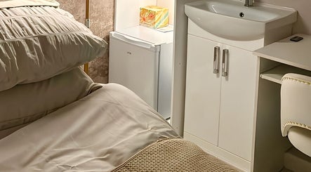 Cozy treatment room at Haven Skin Hamilton, Hamilton, Scotland, GB with plush bedding and modern amenities.