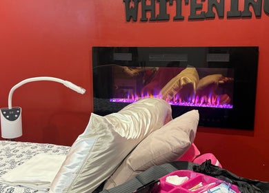 Relaxing treatment space at Lokinda Teeth Whitening, Gatineau, Québec, CA, with modern equipment and ambient fireplace.