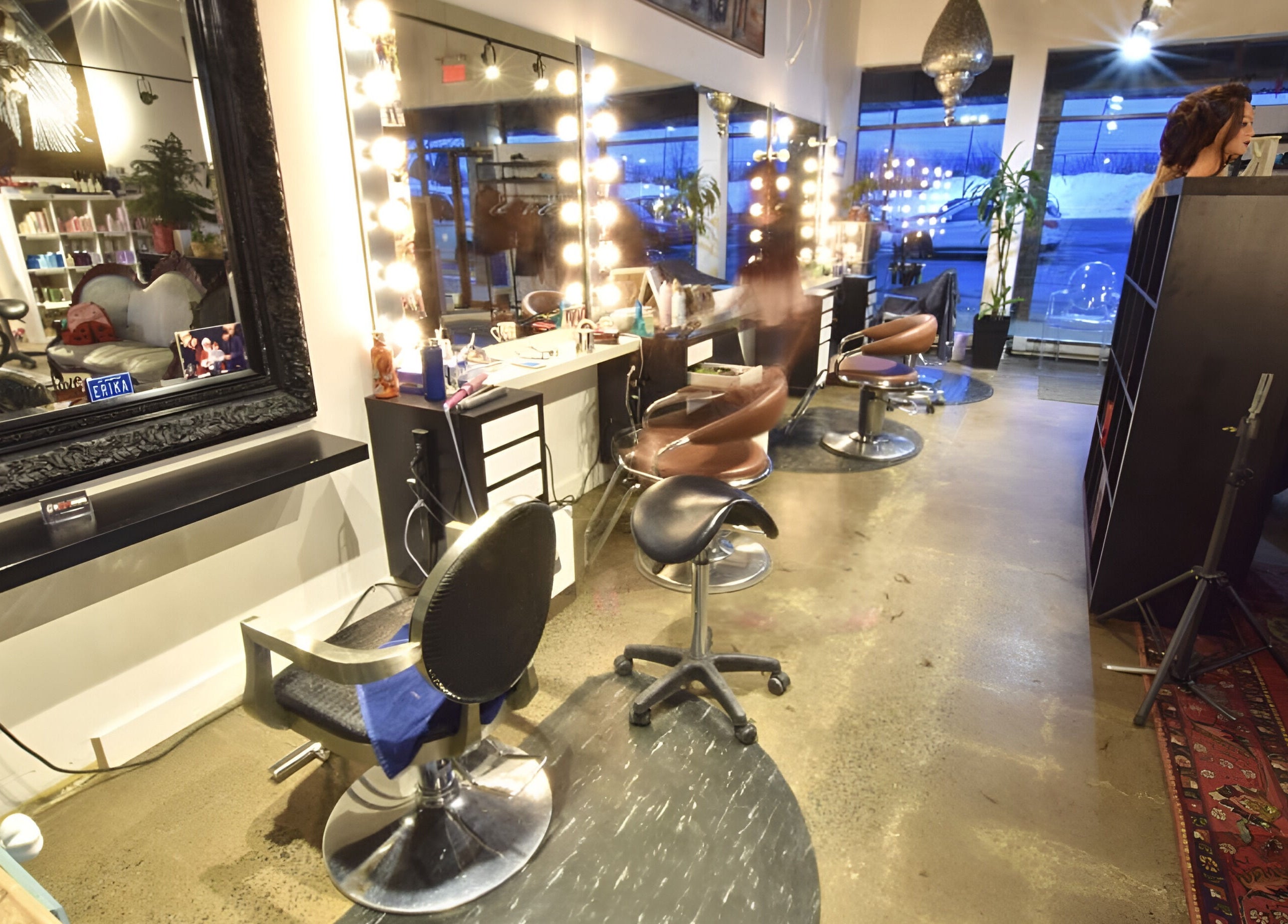 Modern interior of Revolution Hair Studio - Beaconsfield in Beaconsfield, Québec, CA with chic salon chairs.