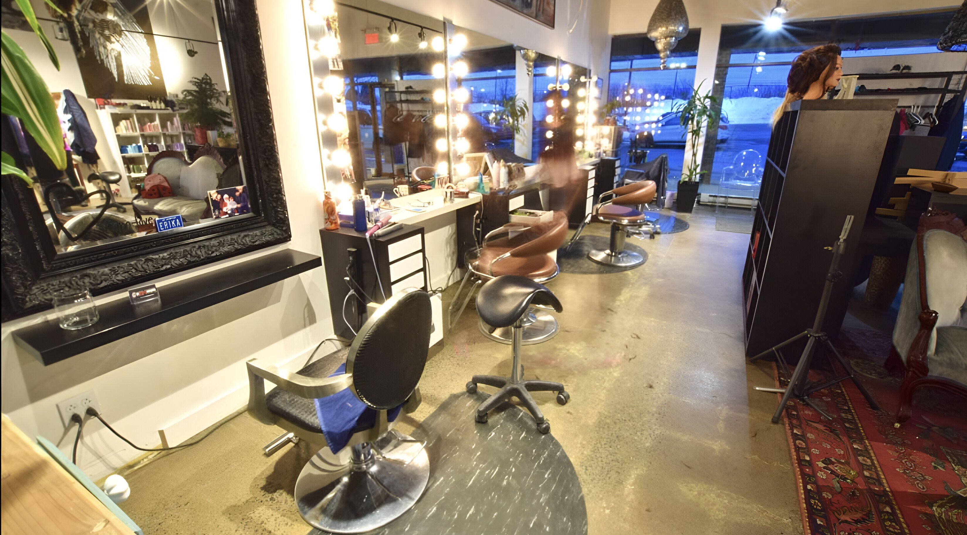 Modern interior of Revolution Hair Studio - Beaconsfield in Beaconsfield, Québec, CA with chic salon chairs.