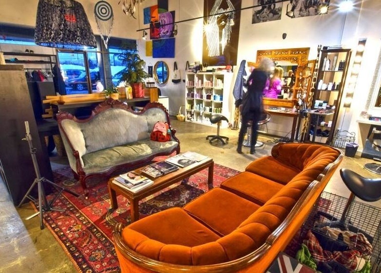 Elegant interior of Revolution Hair Studio - Beaconsfield, Beaconsfield, Québec, CA with plush seating and decor.