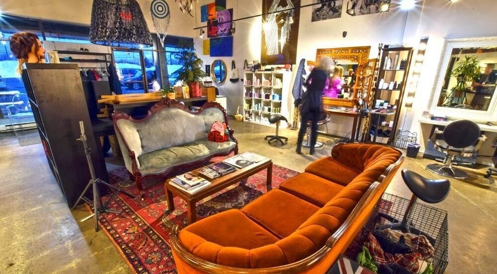 Elegant interior of Revolution Hair Studio - Beaconsfield, Beaconsfield, Québec, CA with plush seating and decor.