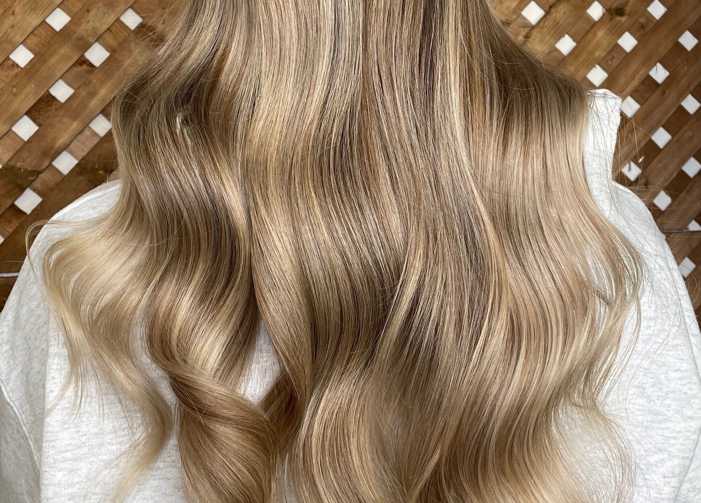 Golden wavy hair styled at Revolution Hair Studio - Beaconsfield. Located in Beaconsfield, Québec, CA.