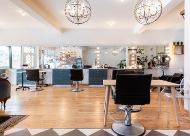 Modern interior of Revolution Hair Studio | St-Henri, Montréal, Québec, CA with stylish chairs and lighting.
