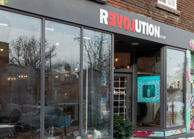 Exterior view of Revolution Hair Studio | St-Henri, in Montréal, Québec, CA with a stylish storefront.