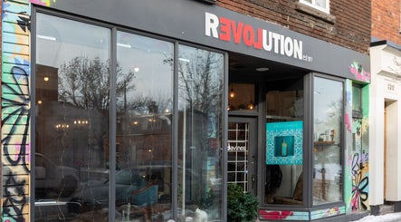 Exterior view of Revolution Hair Studio | St-Henri, in Montréal, Québec, CA with a stylish storefront.
