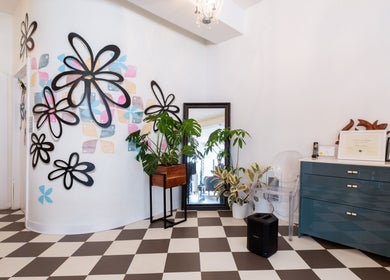 Artistic interior at Revolution Hair Studio | St-Henri, Montréal, Québec, CA, featuring floral wall designs.