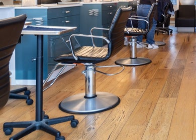 Modern salon chairs at Revolution Hair Studio | St-Henri, Montréal, Québec, CA with stylish wooden floors.