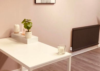 Minimalist therapy room at Rise & Glow Therapies, Cupar, Scotland, GB, featuring a white desk and calming plants.
