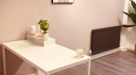 Minimalist therapy room at Rise & Glow Therapies, Cupar, Scotland, GB, featuring a white desk and calming plants.