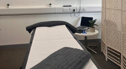 Massage room at DYLIVER Sports Massage & Therapy, Hollywood, England, GB, with a treatment table and serene decor.