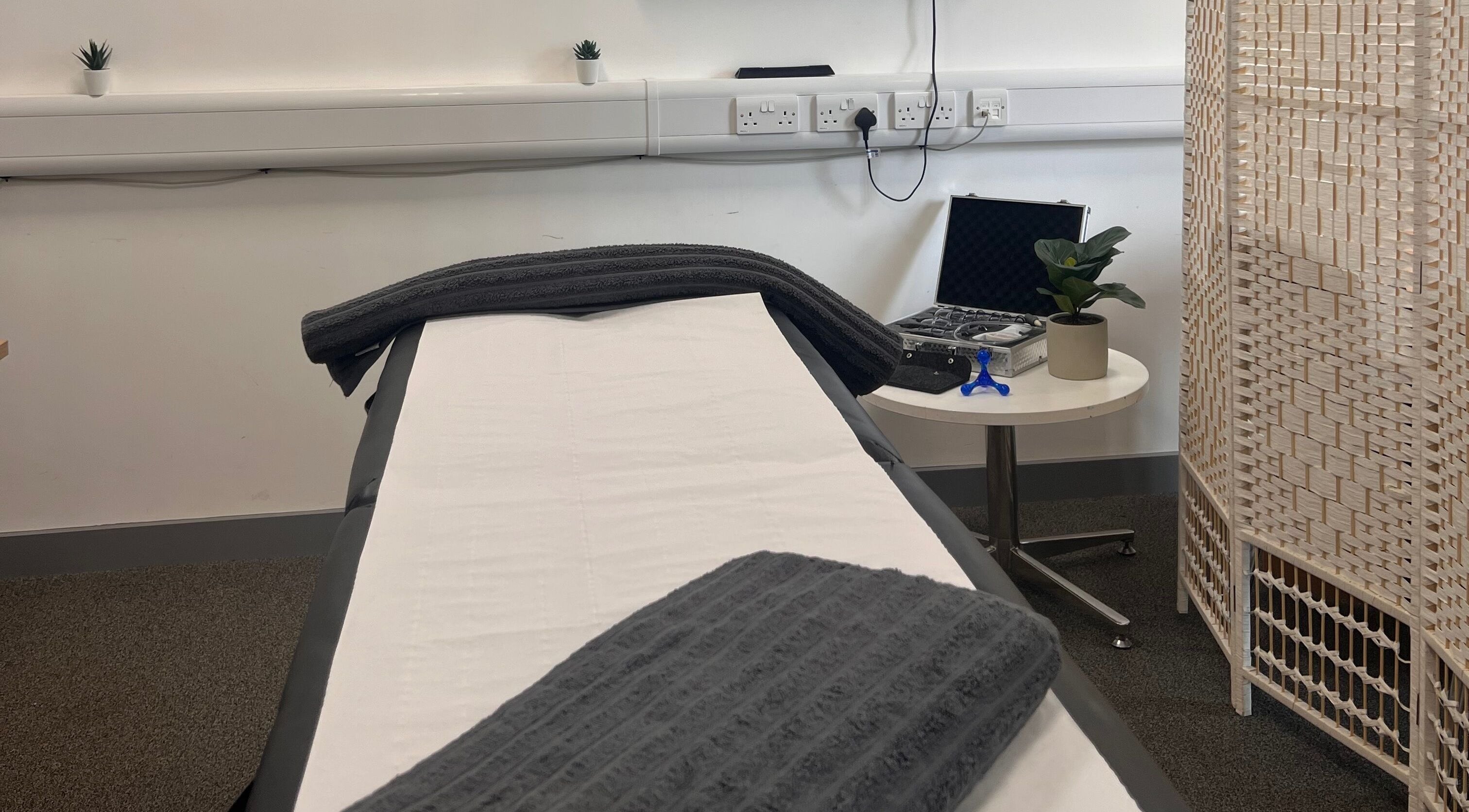 Massage room at DYLIVER Sports Massage & Therapy, Hollywood, England, GB, with a treatment table and serene decor.