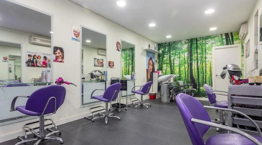 Interior moderno del salón CRISLUZ en Madrid, Comunidad De Madrid, ES con sillas moradas y mural de bosque.