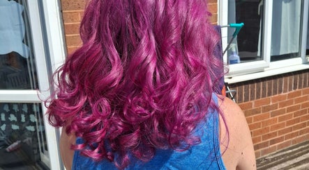 Bright purple curly hair styled at Jades Hair Design in Redditch, England, GB, showcasing vivid color and texture.