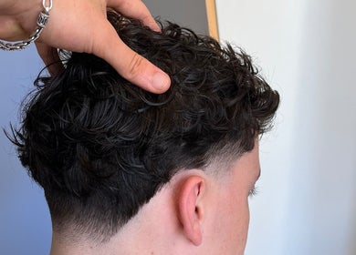 Close-up of a modern curly fade haircut at Boarding Barber, Nyborg, DK, showcasing precision styling.