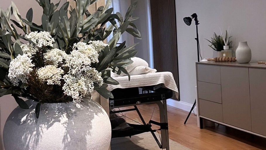 Tranquil treatment room at Sculpt Labs - Marple, Stockport, England, GB featuring elegant decor and floral accents.