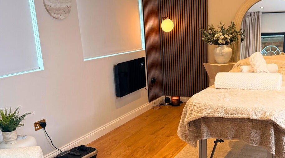 Relaxing massage room at Sculpt Labs - Marple, Stockport, England, GB with cozy decor and soft lighting.