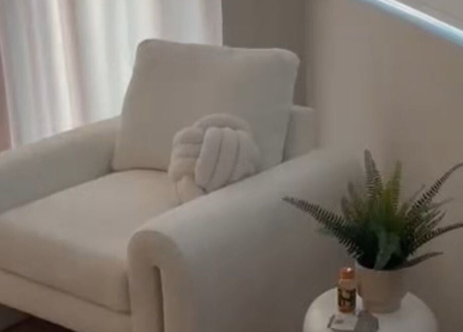 Elegant white chair with plush cushion at Sculpt Labs - Marple, Stockport, England, GB, enhancing wellness ambiance.
