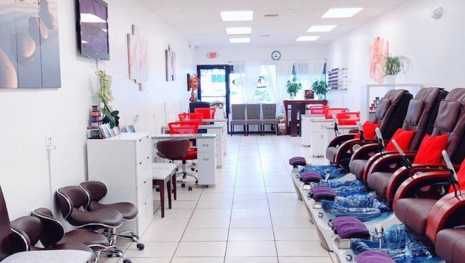 Interior of T Nail Spa, Coral Springs, Florida, showcasing modern nail stations and cozy seating.