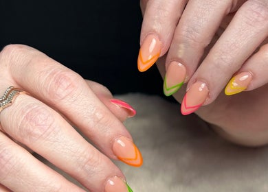 Bright nail art at Glow Up Beauty Lounge by Rei, Fort Meade, Maryland, US showcasing colorful, stylish tips.