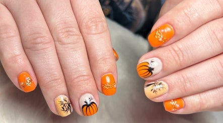 Stylish pumpkin-themed nails at Glow Up Beauty Lounge by Rei in Fort Meade, Maryland, US.