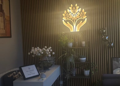 A serene corner at The Metropolis Massage, Surbiton, England, GB, featuring elegant lighting and natural decor.