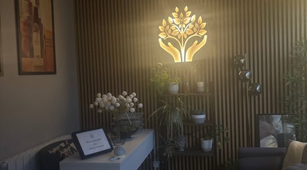 A serene corner at The Metropolis Massage, Surbiton, England, GB, featuring elegant lighting and natural decor.
