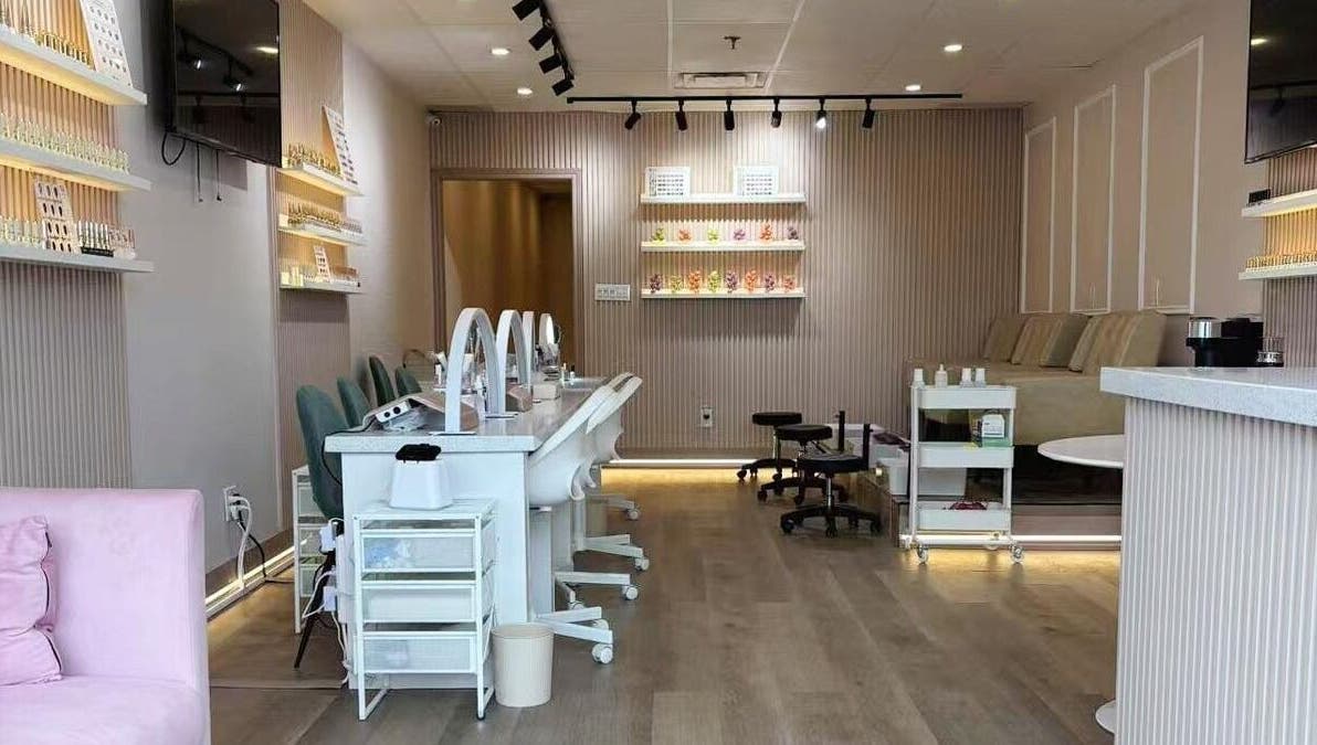 Stylish interior of Zoey Beauty Bar in Mississauga, Ontario, CA, showcasing manicure stations and elegant decor.