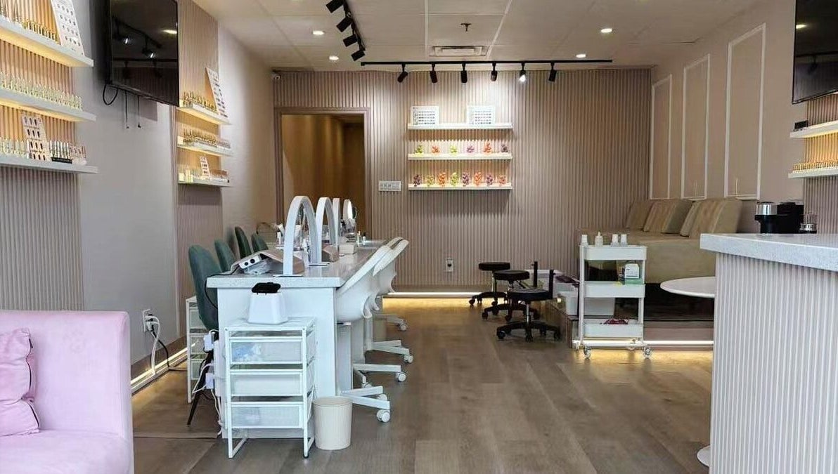 Stylish interior of Zoey Beauty Bar in Mississauga, Ontario, CA, showcasing manicure stations and elegant decor.