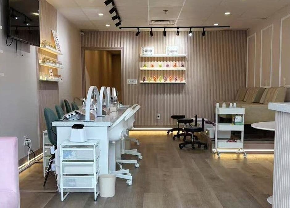 Stylish interior of Zoey Beauty Bar in Mississauga, Ontario, CA, showcasing manicure stations and elegant decor.