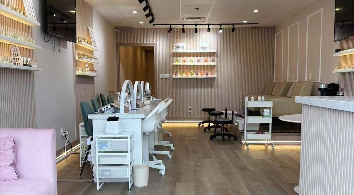 Stylish interior of Zoey Beauty Bar in Mississauga, Ontario, CA, showcasing manicure stations and elegant decor.