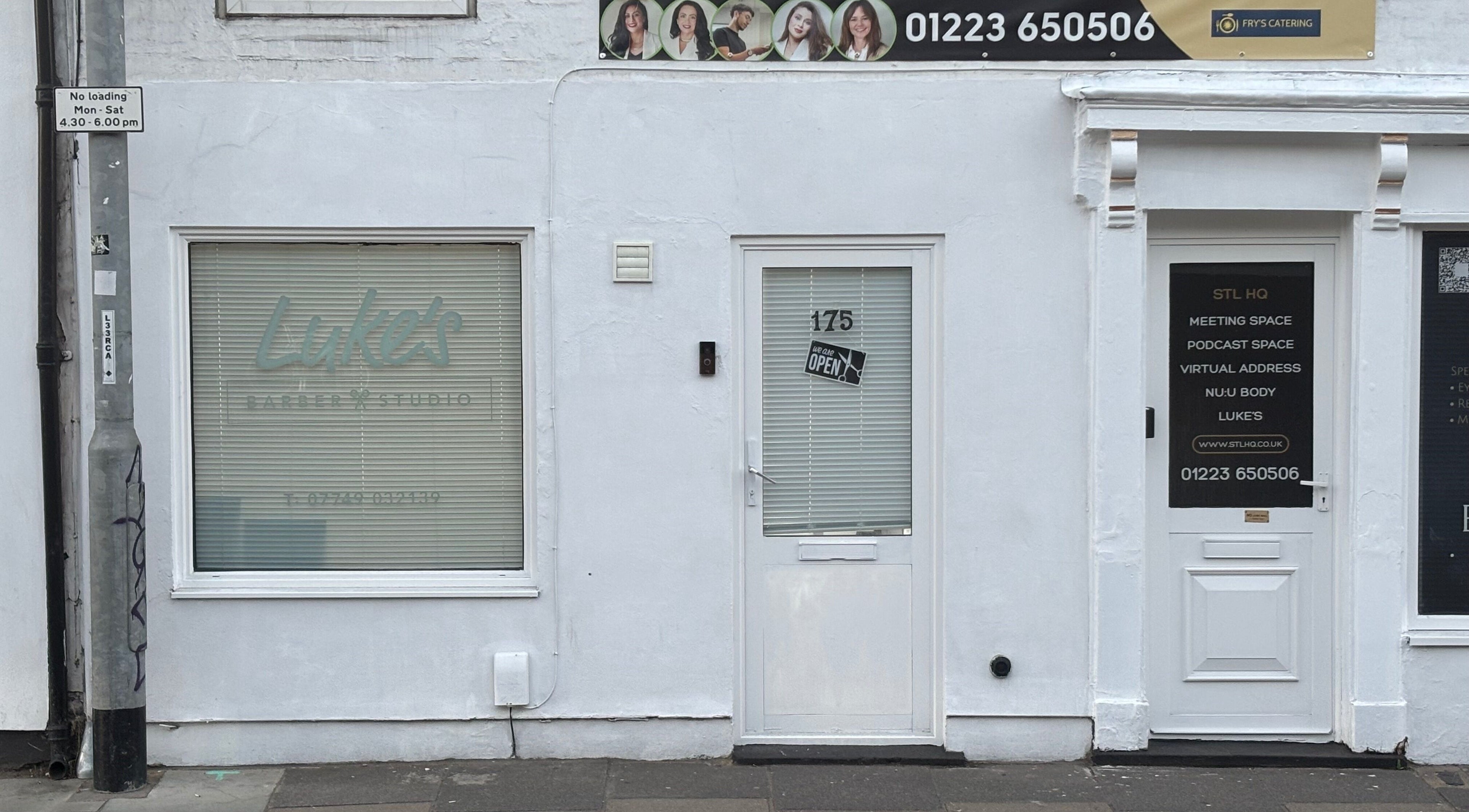 Front entrance of Alfie (Luke’s Studio) in Cambridge, England, GB with signage and contact details.