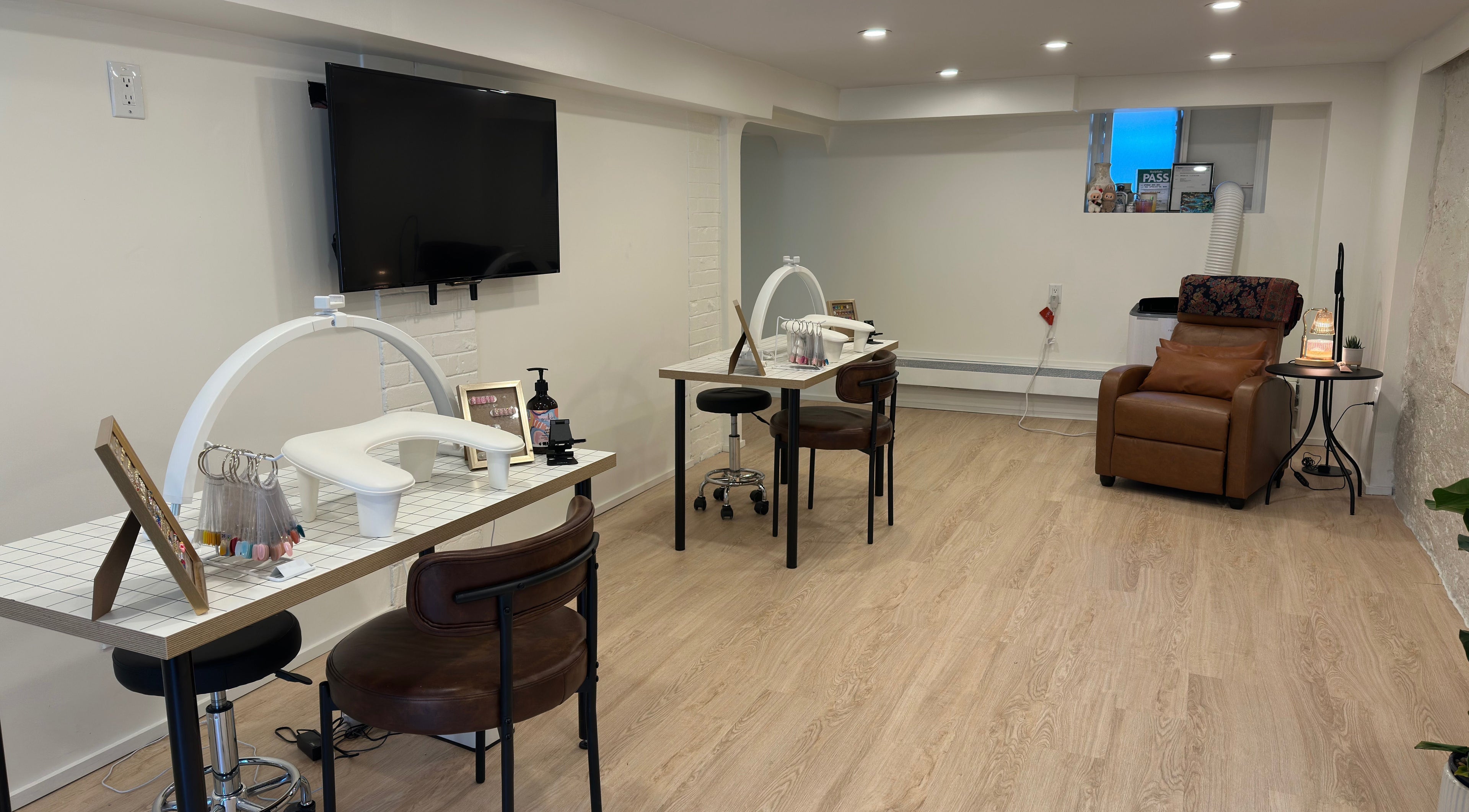 Modern nail service area at Studio Enu, featuring stylish seating, Toronto, Ontario, CA.