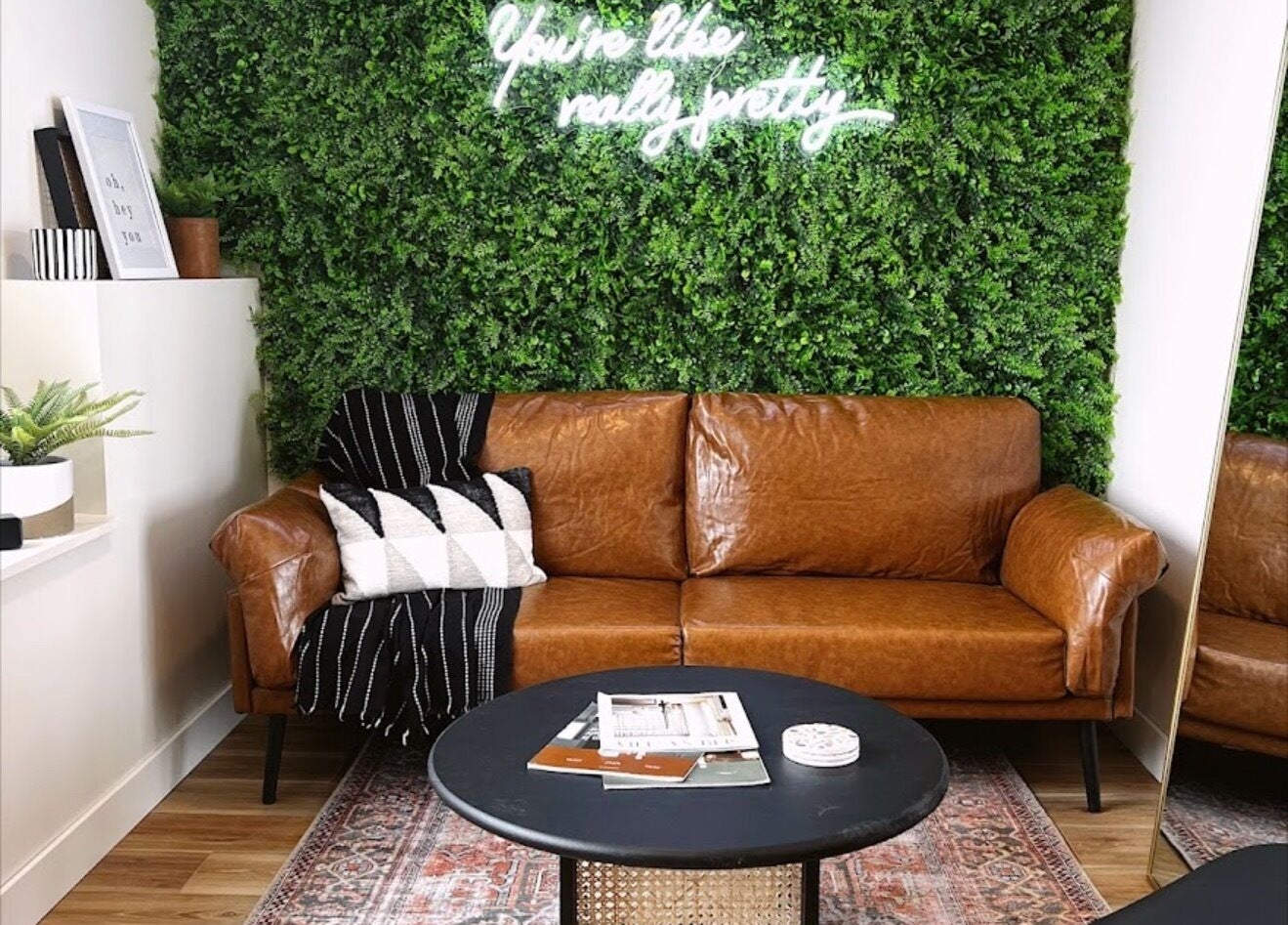 Cozy brown leather sofa with greenery at Sol Aesthetics-Hastings, Hastings, Minnesota, US.