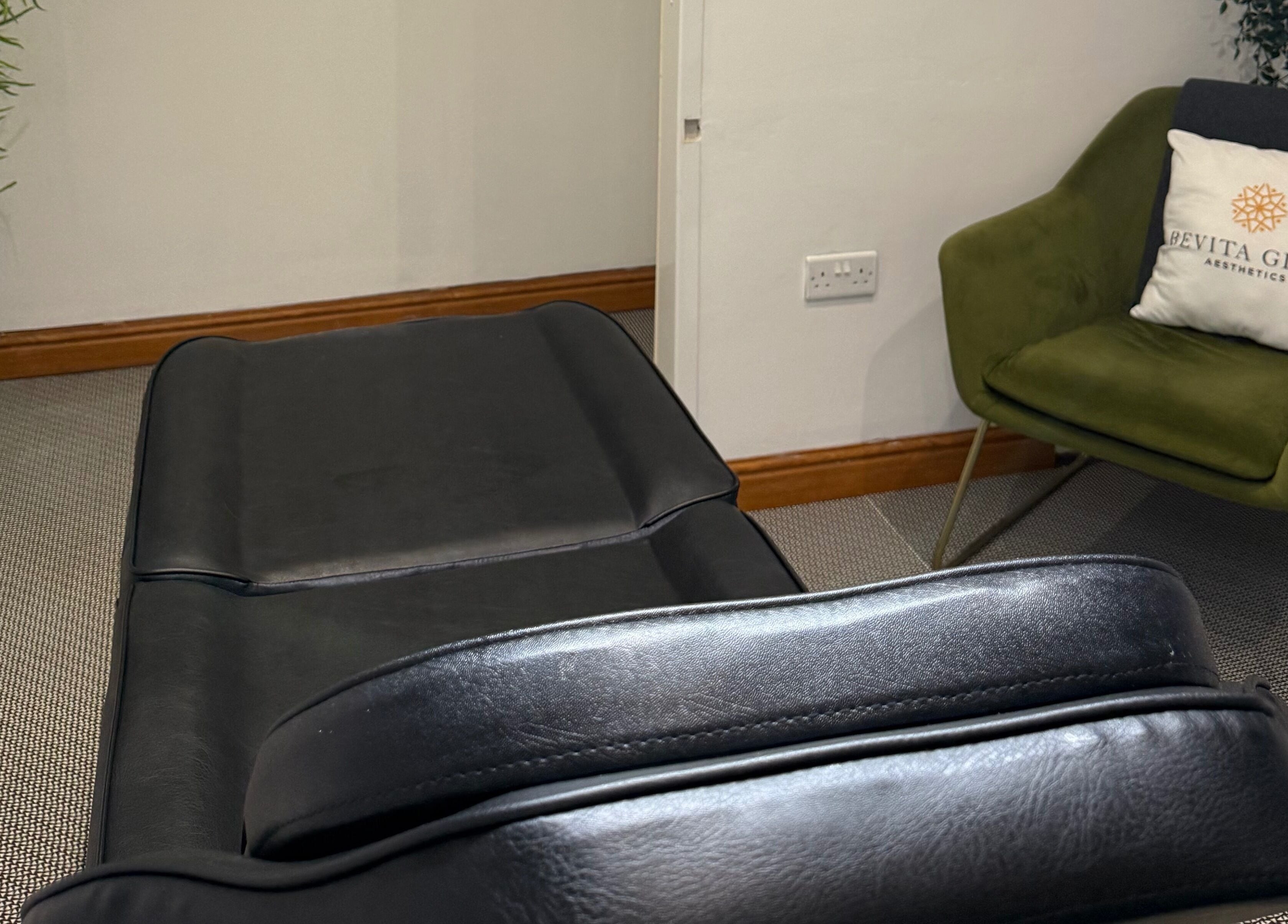 Luxurious treatment room at Revitaglow Aesthetics and Wellness, Derby, England, GB with black spa bed.