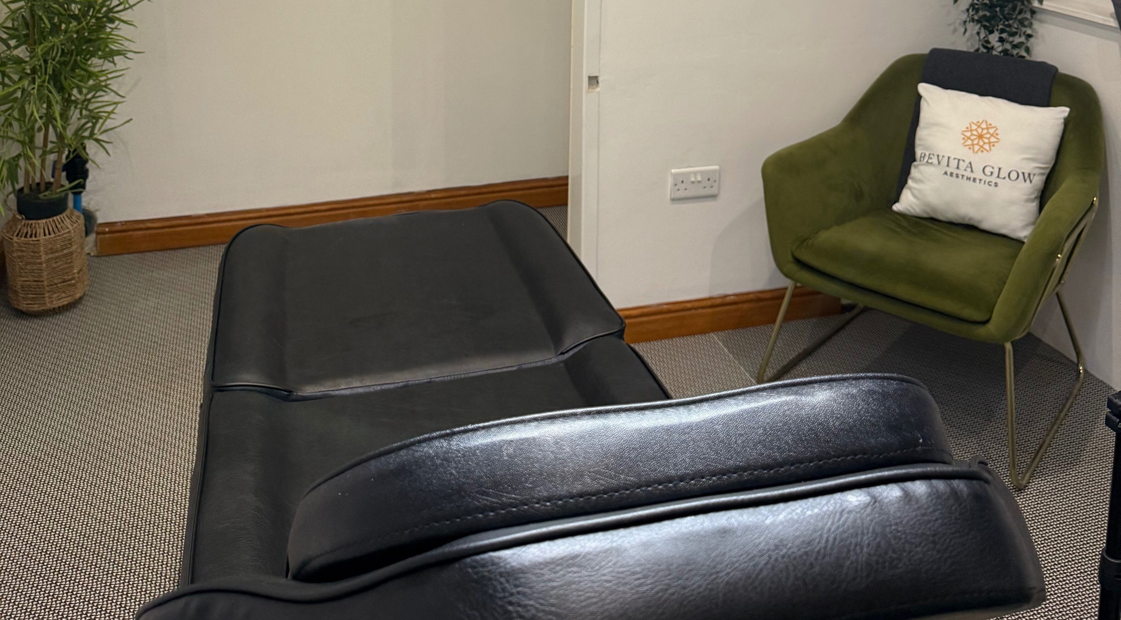 Luxurious treatment room at Revitaglow Aesthetics and Wellness, Derby, England, GB with black spa bed.