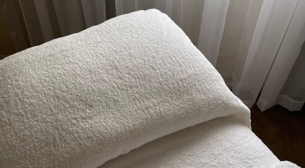 Plush white towel on spa table at Kalari Body and Face, Andergrove, Queensland, AU. Relaxing ambiance.