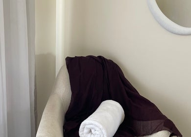 Cozy chair with towel at Kalari Body and Face, Andergrove, Queensland, AU, creating a relaxing ambiance.