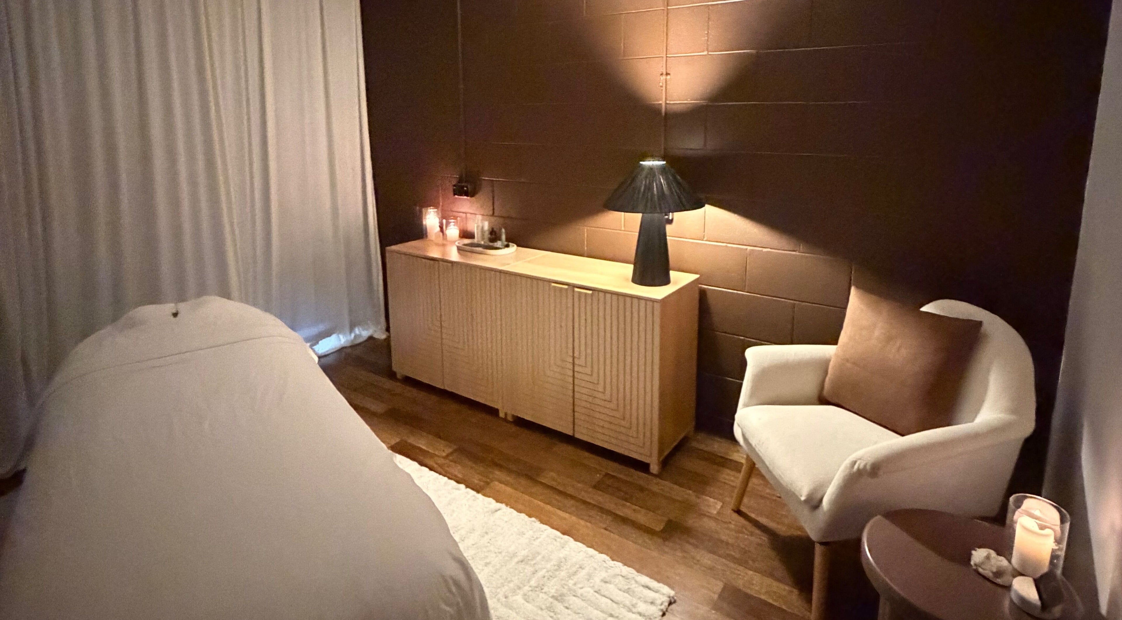 Elegant treatment room at Kalari Body and Face, East Mackay, Queensland, AU, featuring a cozy white chair and soft lighting.
