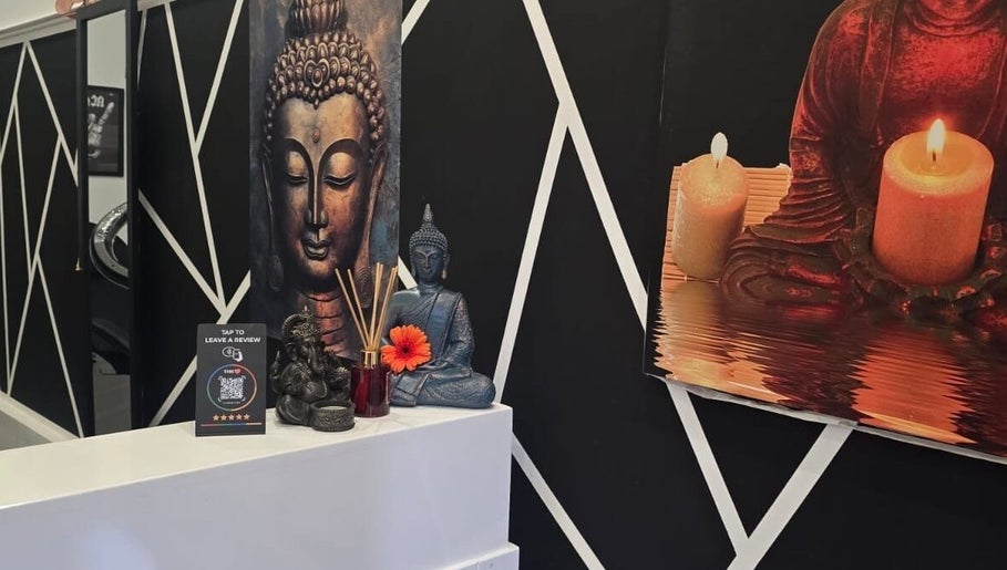 Peaceful Buddha art and candles at Teel Ink'd Tattoo in Rochdale, England, GB, enhancing the calming atmosphere.
