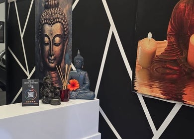 Peaceful Buddha art and candles at Teel Ink'd Tattoo in Rochdale, England, GB, enhancing the calming atmosphere.