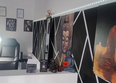 Relaxing interior of Teel Ink'd Tattoo in Rochdale, England, GB with a serene Buddha painting and comfy chair.