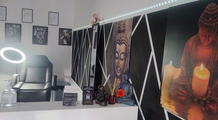 Relaxing interior of Teel Ink'd Tattoo in Rochdale, England, GB with a serene Buddha painting and comfy chair.