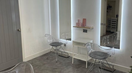 Modern styling area at Citrus Hair Bar, Edinburgh, Scotland, GB, featuring clear chairs and illuminated mirrors.