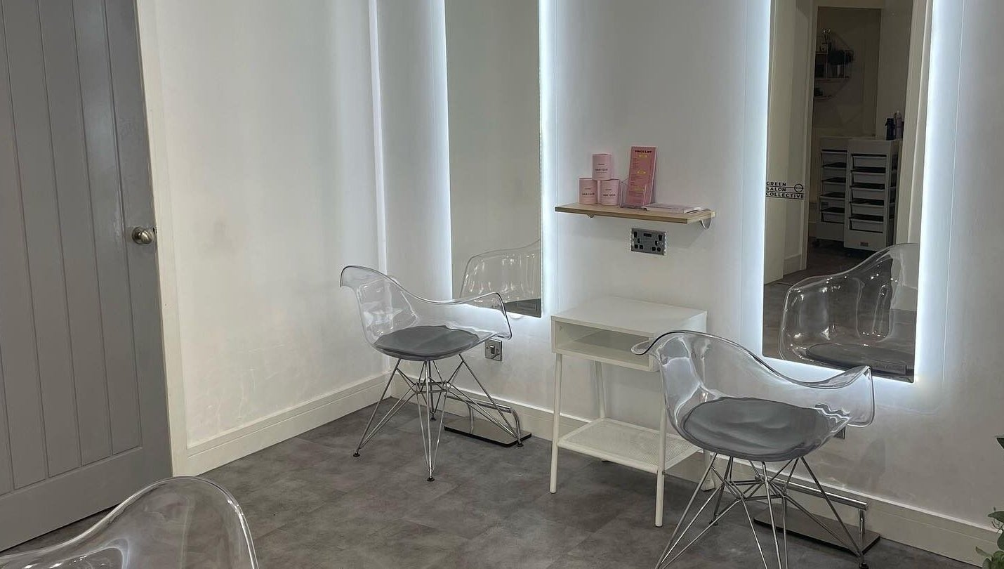 Modern styling station at Citrus Hair Bar, Edinburgh, Scotland, GB, featuring sleek transparent chairs with illuminated mirrors.