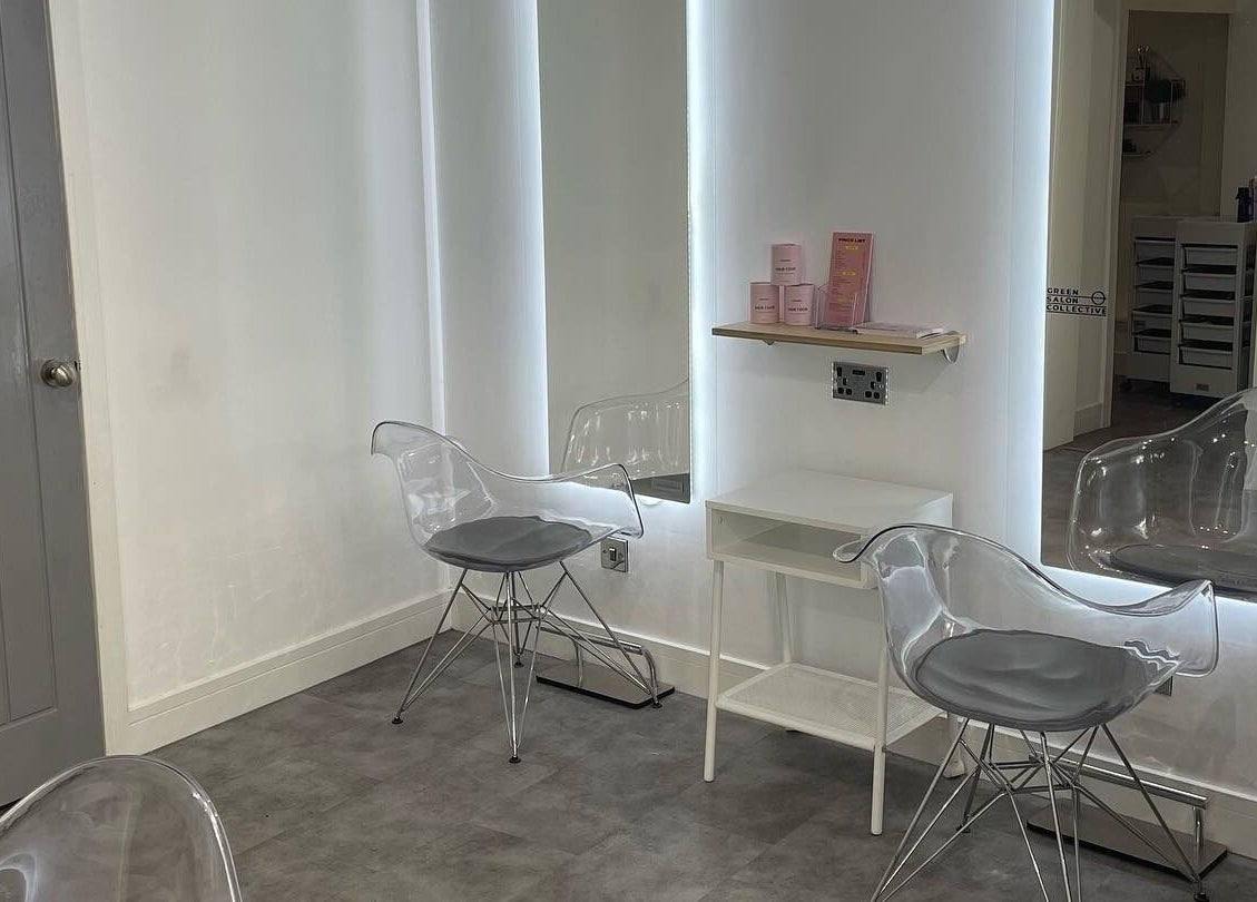 Modern styling station at Citrus Hair Bar, Edinburgh, Scotland, GB, featuring sleek transparent chairs with illuminated mirrors.