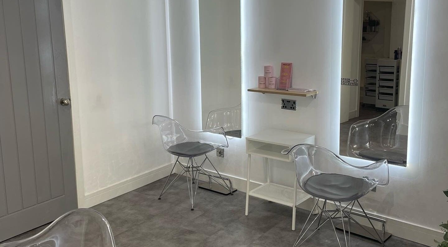 Modern styling station at Citrus Hair Bar, Edinburgh, Scotland, GB, featuring sleek transparent chairs with illuminated mirrors.